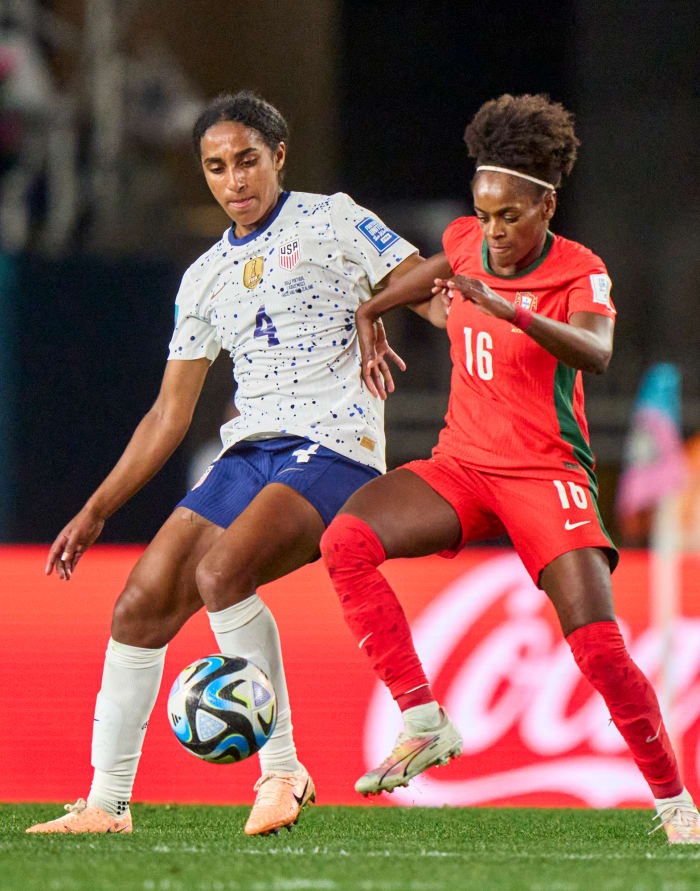 Naomi Girma battles for a ball against a Portugese player during the World Cup.